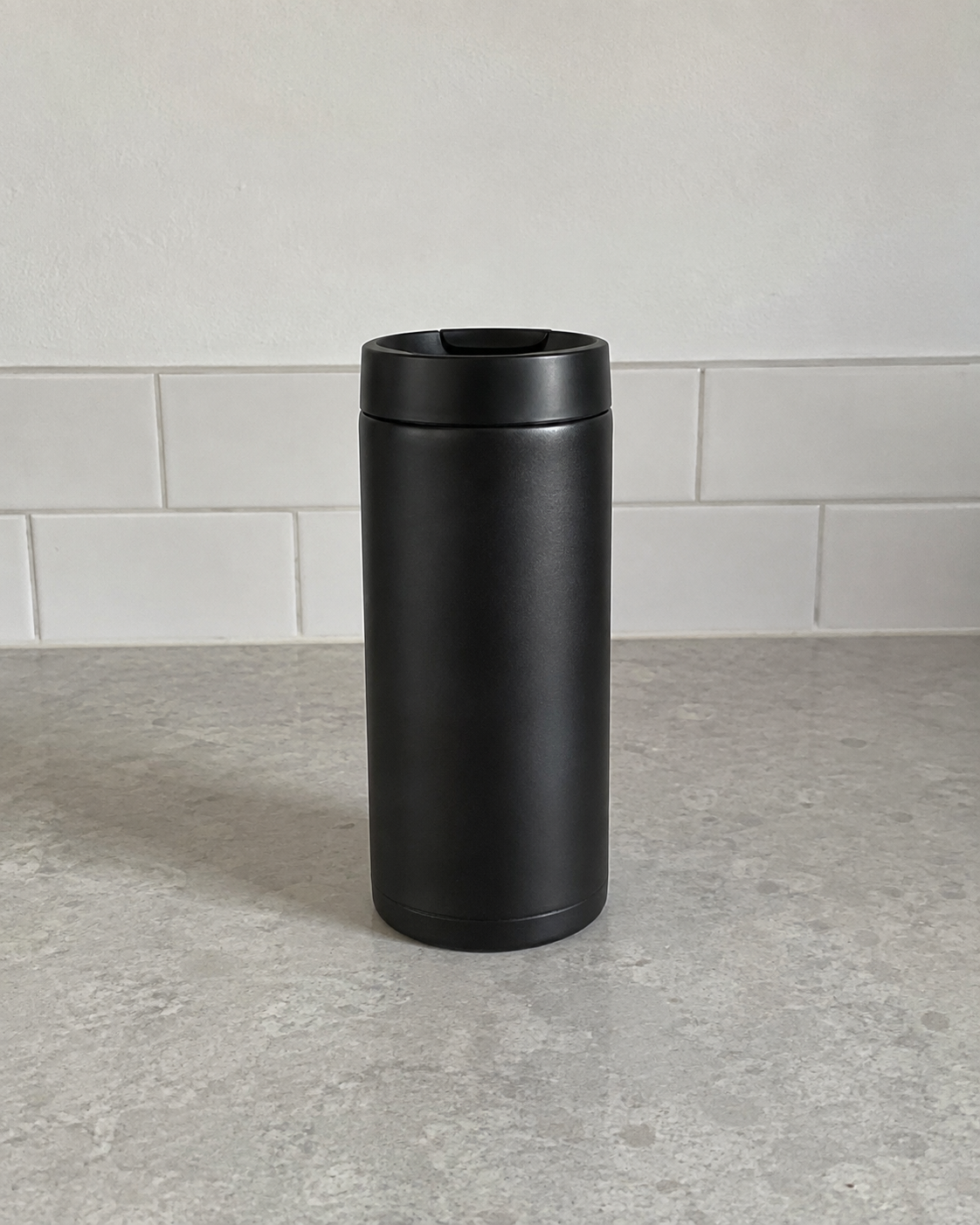 Plain unbranded matte-black travel tumbler used as the test reference
